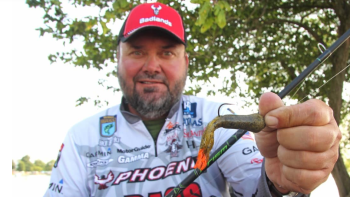 Greg Hackney holding up a lure with the tips dyed orange