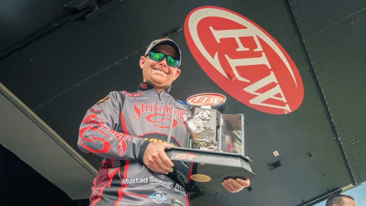 Andrew Upshaw holding out FLW trophy