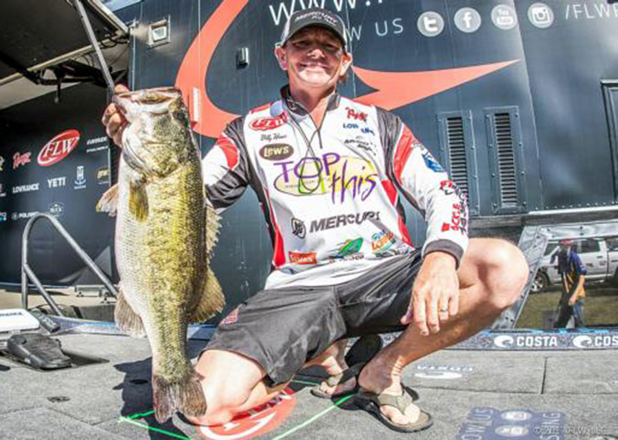 Billy Hines holding out a largemouth bass caught in tournament