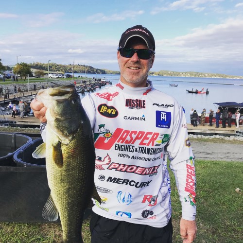 Chad Morgenthaler holding out a bass caught in competition