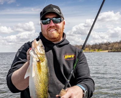 Drake Herd holding out a walleye caught on a Lew's Speed Stick