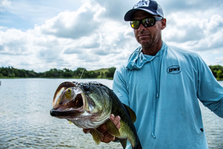 Todd Castledine holding out a bass caught on the Hybrid Hunter