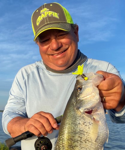 Wally Marshall holding out a crappie caught on a Mr. Crappie Thunder lure